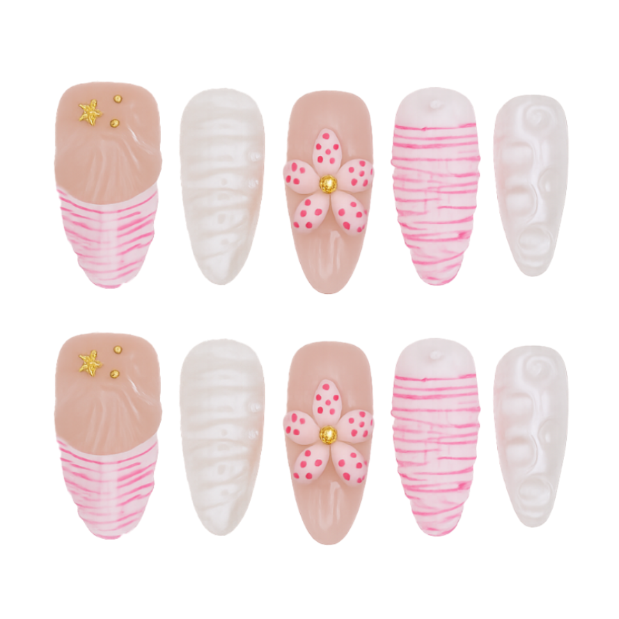 Set of decorative press-on nails with pink and white designs on a white background
